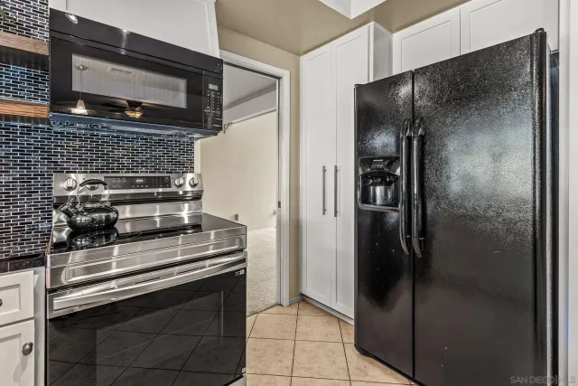 a kitchen with a refrigerator and a stove