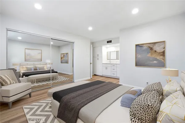 a bedroom with a bed and wooden floor