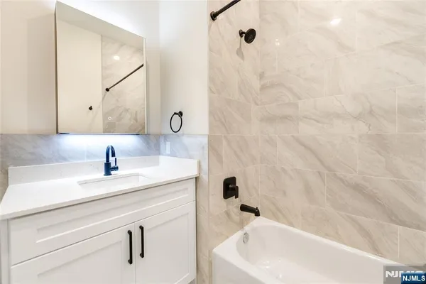 a bathroom with a sink a mirror and shower