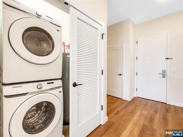 a view of a hallway with washer and dryer