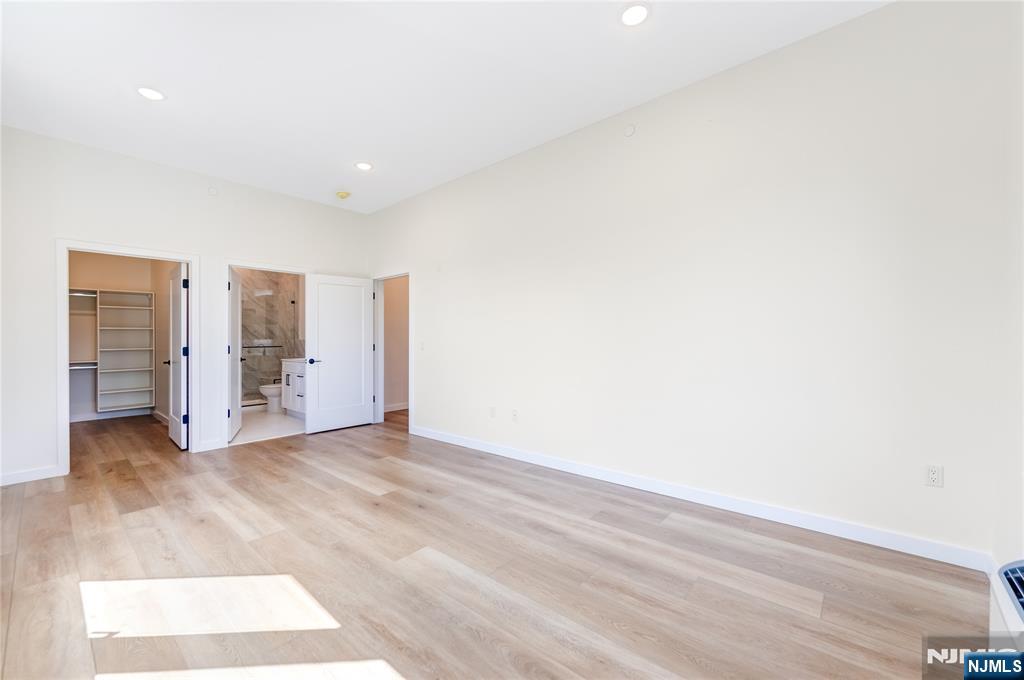 51 Queen Anne Road, Unit 207 Bogota, NJ 07603 - Photo 9 of 22 a view of an empty room with wooden floor