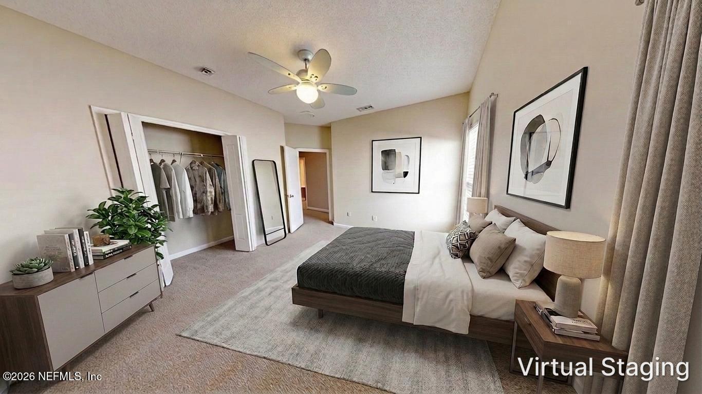 14454 Millhopper Road Jacksonville, FL 32258 - Photo 26 of 44 a living room with furniture and a chandelier