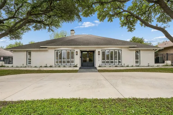 a front view of a house with a garden and porch