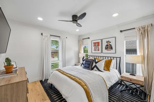 a bedroom with a bed and wooden floor