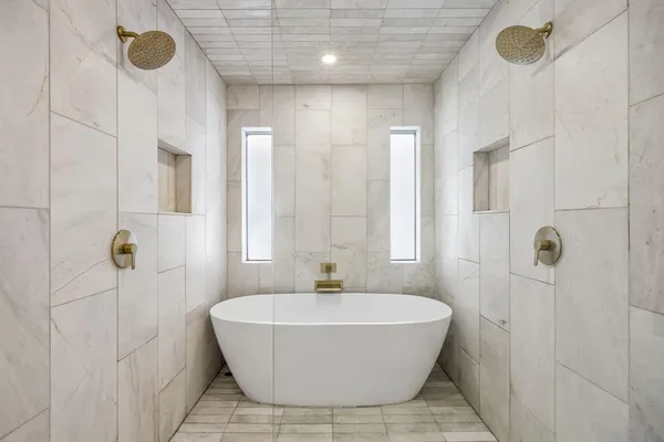 a bathroom with a bathtub and shower