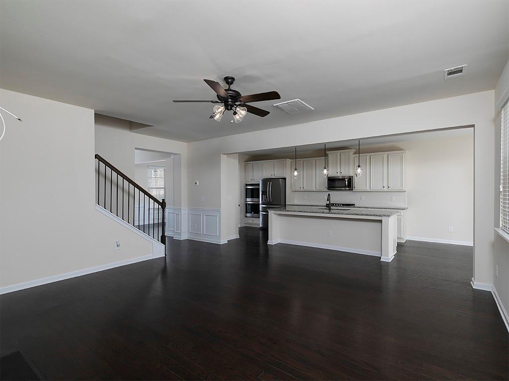 488 Victoria Heights Dr. Dallas, GA 30132 - Photo 13 of 45 a view of an empty room with wooden floor and a kitchen