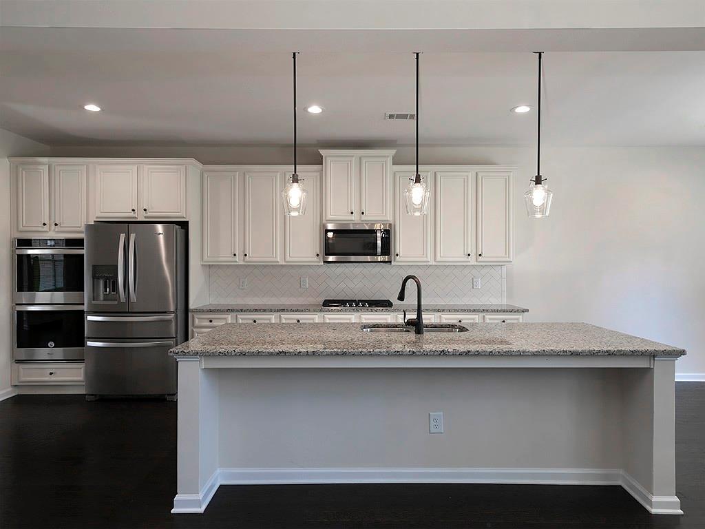 488 Victoria Heights Dr. Dallas, GA 30132 - Photo 15 of 45 a kitchen with kitchen island a sink stainless steel appliances and cabinets
