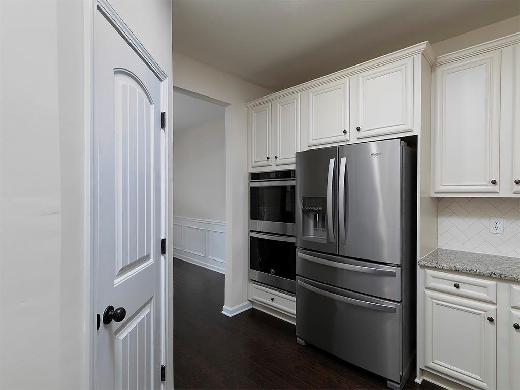 488 Victoria Heights Dr. Dallas, GA 30132 - Photo 16 of 45 a view of a refrigerator in kitchen and white cabinets