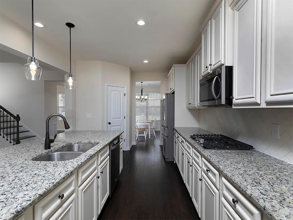 488 Victoria Heights Dr. Dallas, GA 30132 - Photo 17 of 45 a kitchen with kitchen island granite countertop a sink a counter top space appliances and cabinets