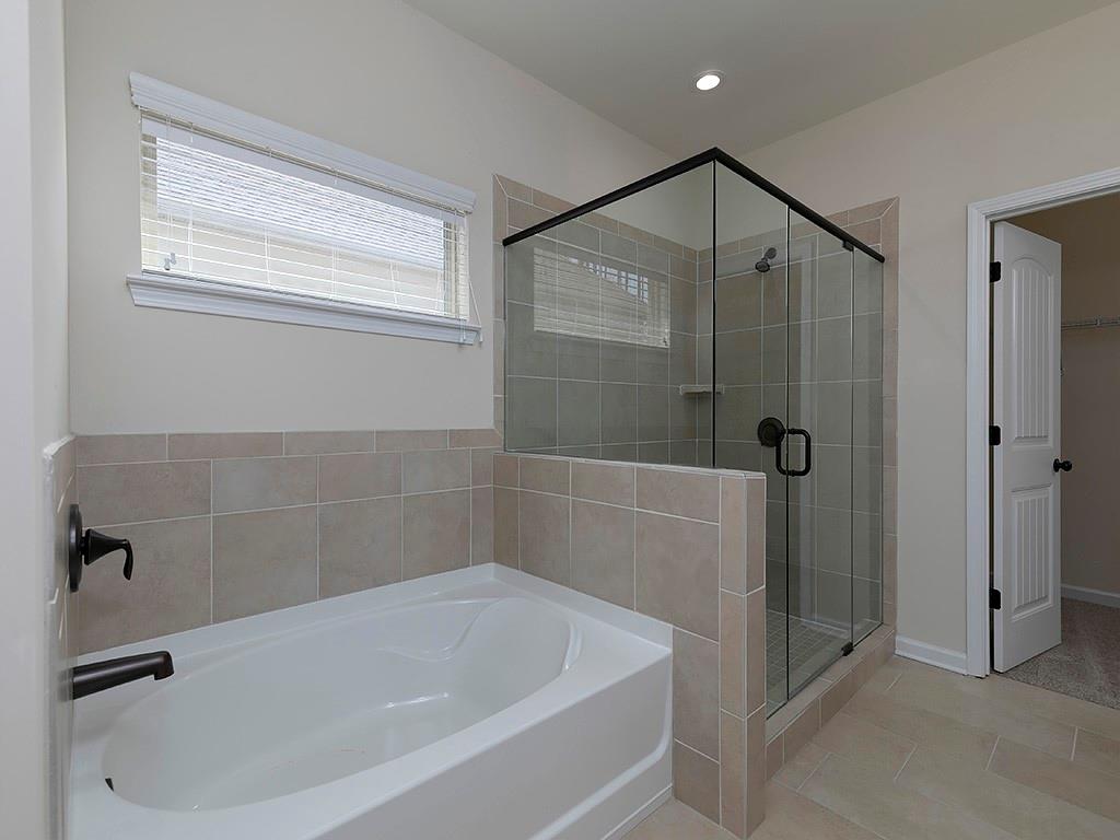 488 Victoria Heights Dr. Dallas, GA 30132 - Photo 29 of 45 a white bath tub sitting next to a shower