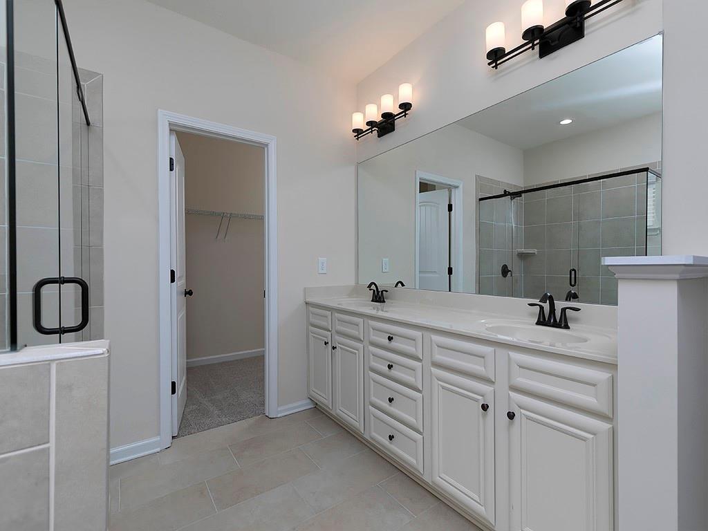 488 Victoria Heights Dr. Dallas, GA 30132 - Photo 30 of 45 a bathroom with a double vanity sink mirror and shower