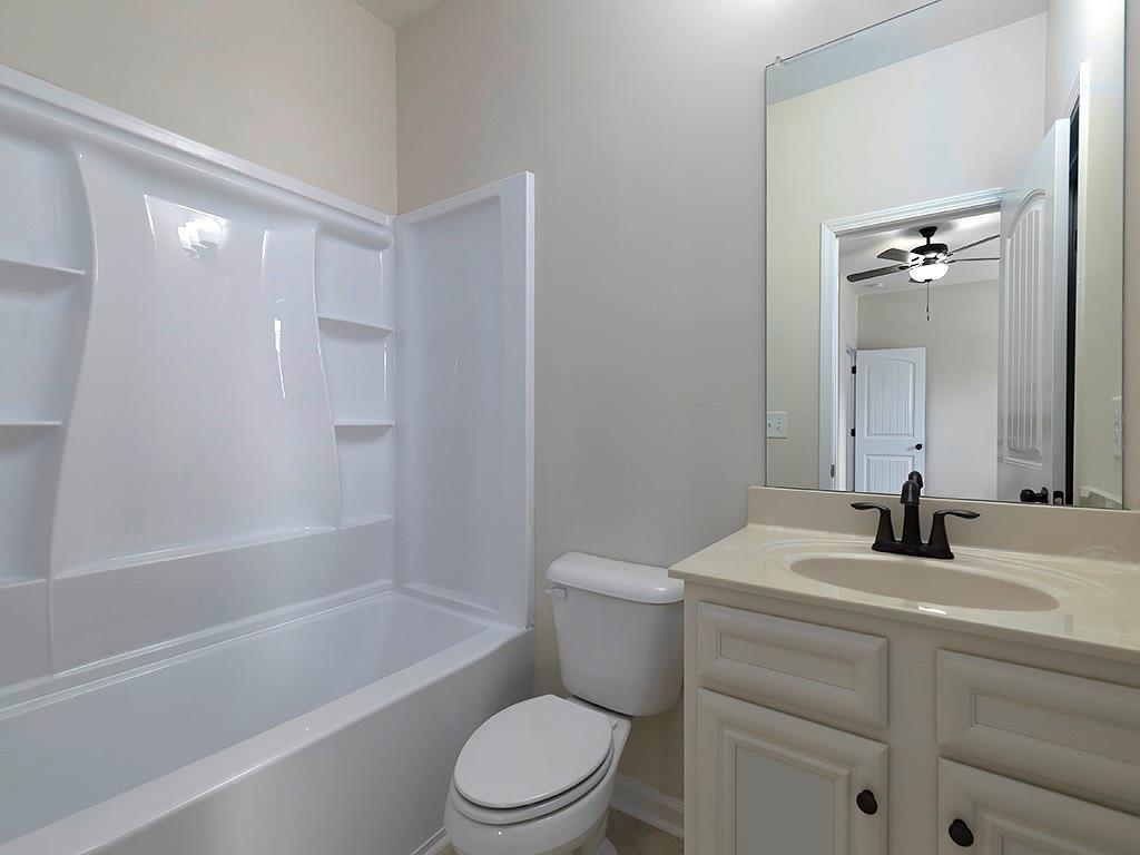 488 Victoria Heights Dr. Dallas, GA 30132 - Photo 33 of 45 a bathroom with a bathtub shower sink vanity mirror and toilet