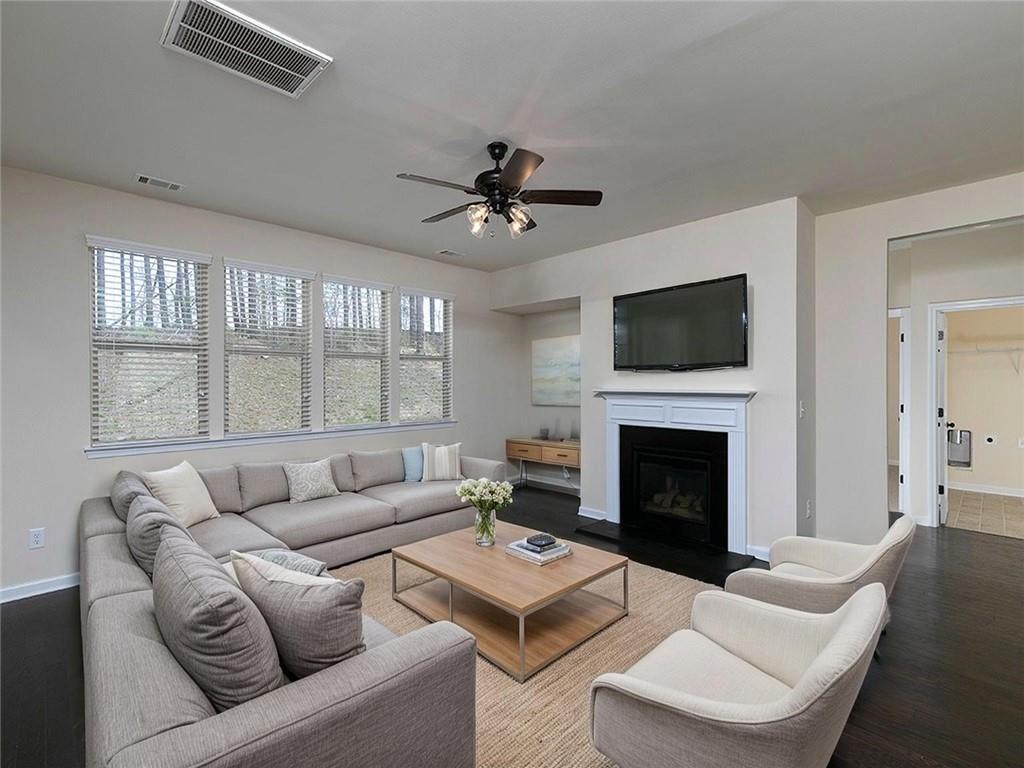 488 Victoria Heights Dr. Dallas, GA 30132 - Photo 4 of 45 a living room with furniture a fireplace and a flat screen tv