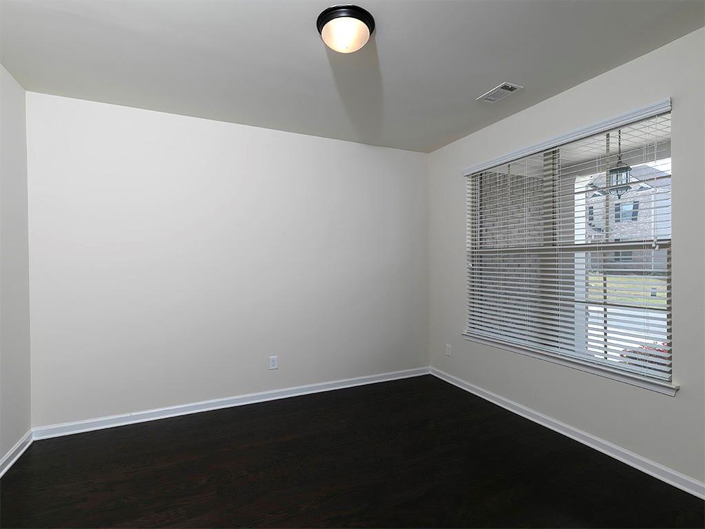 488 Victoria Heights Dr. Dallas, GA 30132 - Photo 10 of 45 a view of an empty room with wooden floor and a window