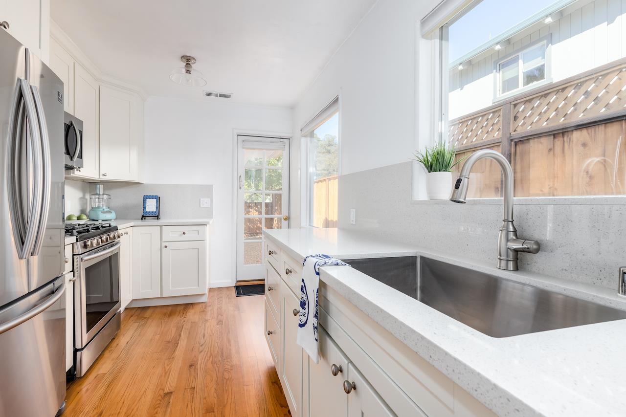 2891 Scriver Street Santa Cruz, CA 95062 - Photo 11 of 30 a kitchen with a sink wooden floor and stainless steel appliances