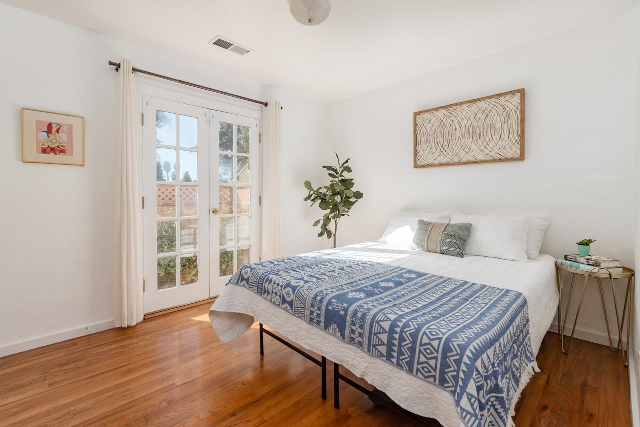 2891 Scriver Street Santa Cruz, CA 95062 - Photo 17 of 30 a bedroom with a large bed and a wooden floor