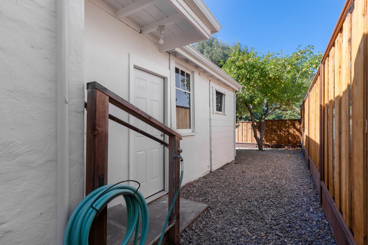 2891 Scriver Street Santa Cruz, CA 95062 - Photo 23 of 30 a backyard of a house with large tree and wooden fence