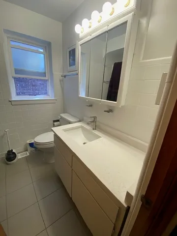 a bathroom with a sink a toilet and mirror
