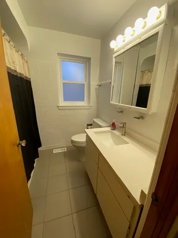 a bathroom with a granite countertop sink a mirror and a bathtub