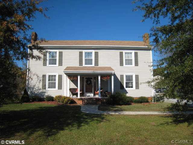 22987 Prince Edward Highway Rice, VA 23966 - Photo 1 of 10 a front view of a house with garden and trees