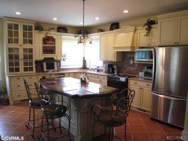 22987 Prince Edward Highway Rice, VA 23966 - Photo 2 of 10 a kitchen with stainless steel appliances granite countertop a sink a stove a refrigerator dining table and chairs