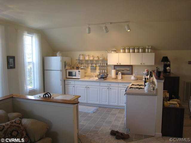 22987 Prince Edward Highway Rice, VA 23966 - Photo 6 of 10 a kitchen with refrigerator and cabinets