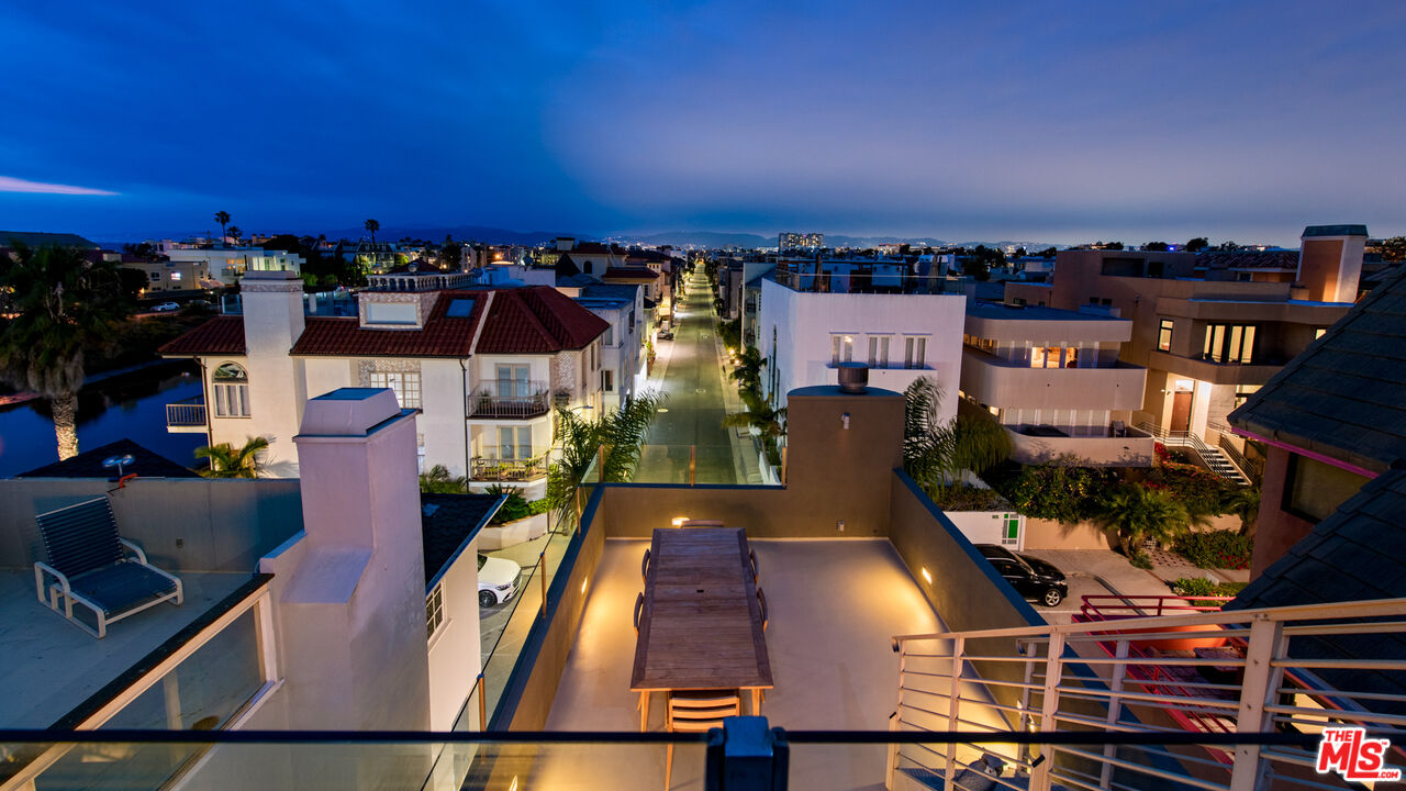 an aerial view of a balcony with chairs