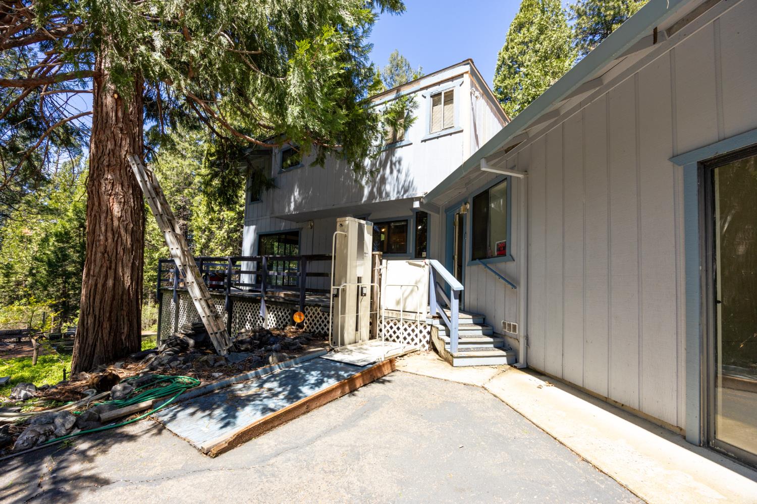 2070 King Of The Mountain Road Pollock Pines, CA 95726 - Photo 3 of 53 a view of a patio with table and chairs a barbeque and a large tree