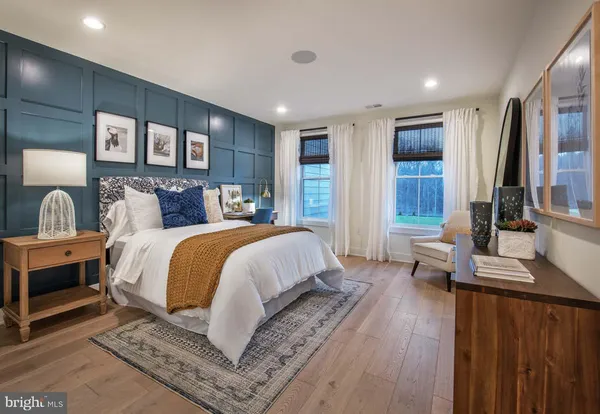a bedroom with a large bed and a dresser