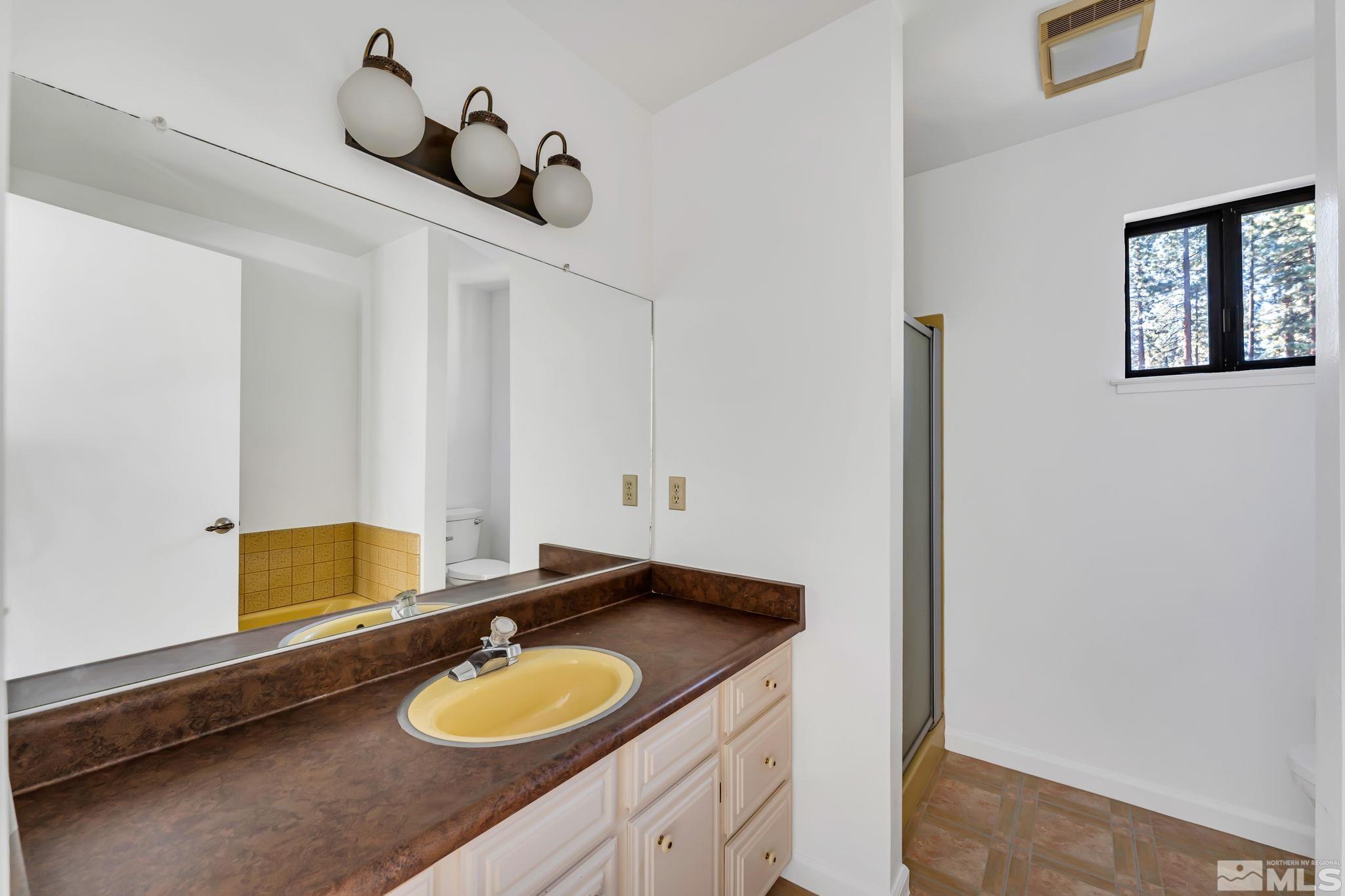 213 Chimney Rock Road Stateline, NV 89449 - Photo 25 of 37 a bathroom with a granite countertop sink and a mirror