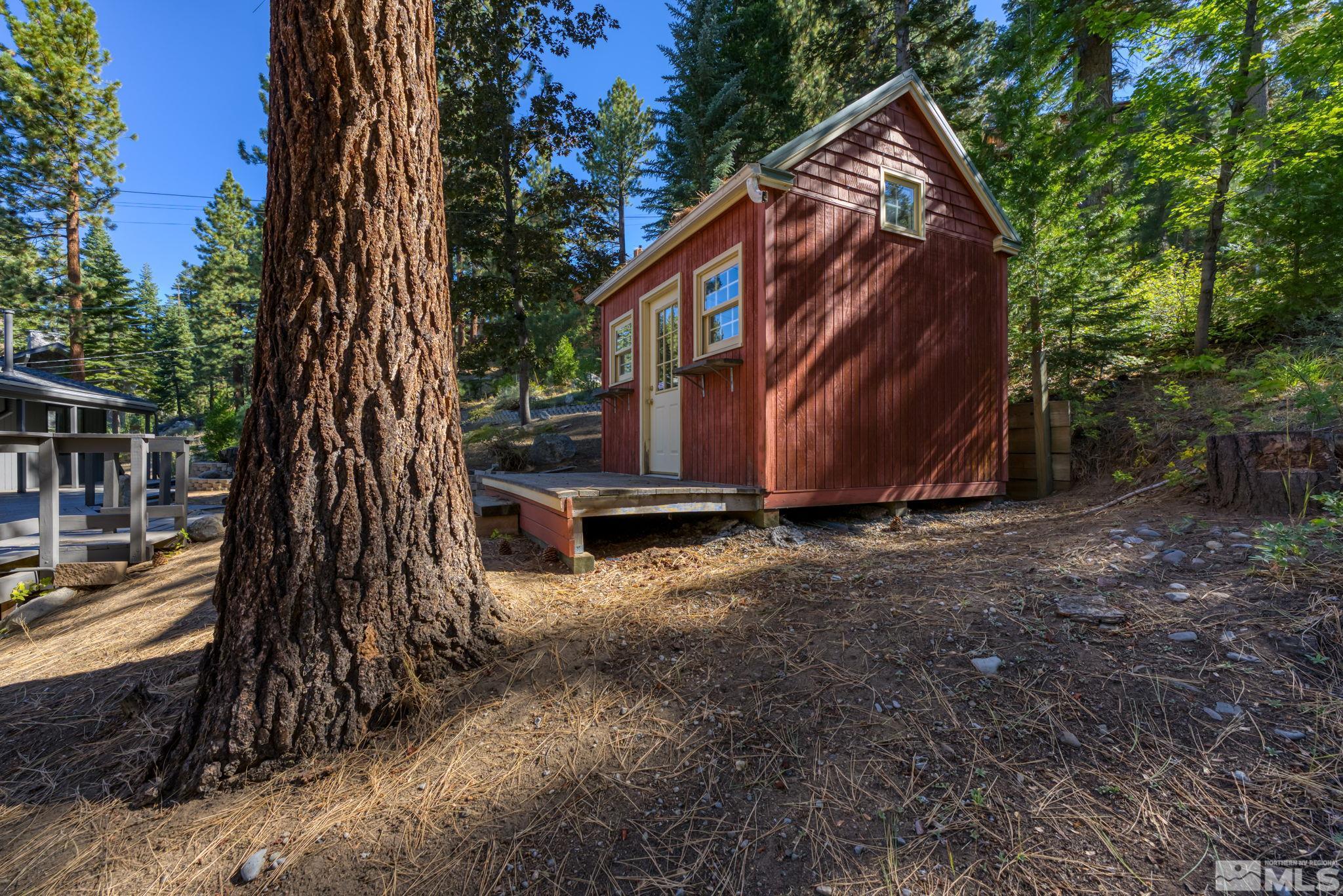 213 Chimney Rock Road Stateline, NV 89449 - Photo 34 of 37 a view of backyard with large trees and wooden fence