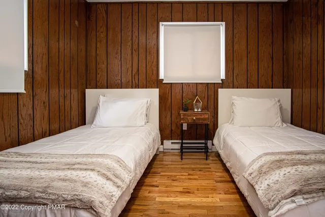 a bedroom with a large bed and a chandelier