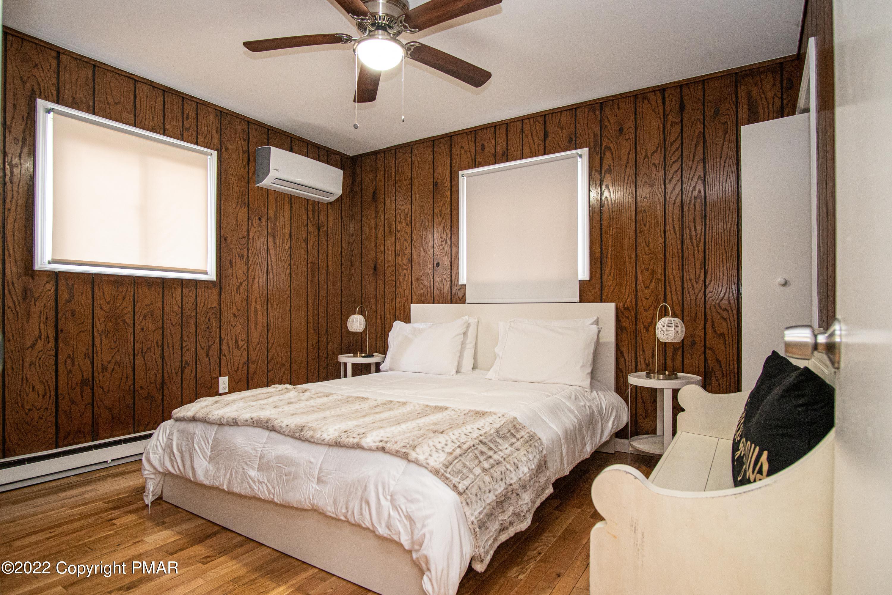 125 Edinburgh Road Bushkill, PA 18324 - Photo 15 of 64 a bedroom with a large bed and a chandelier