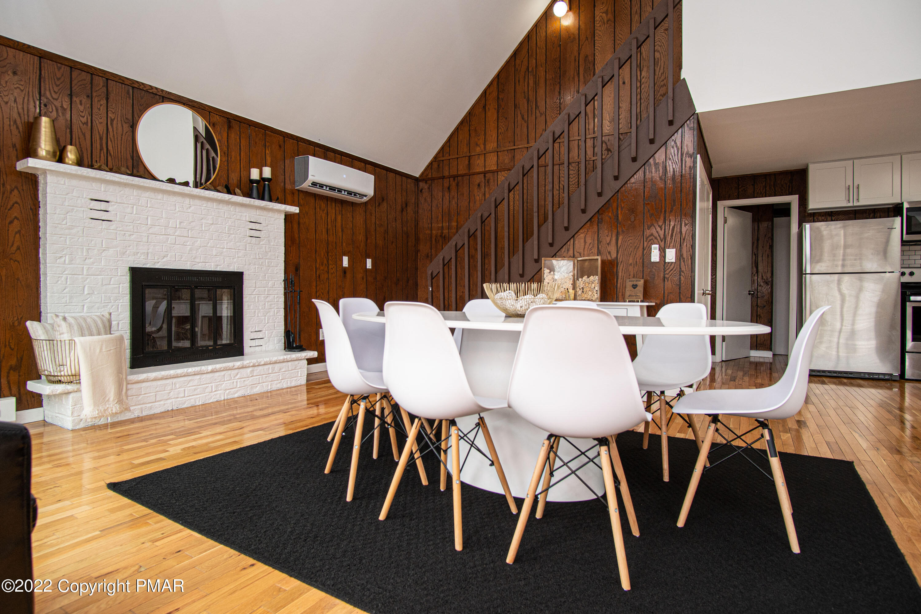 125 Edinburgh Road Bushkill, PA 18324 - Photo 20 of 64 a dining room with furniture a fireplace and wooden floor