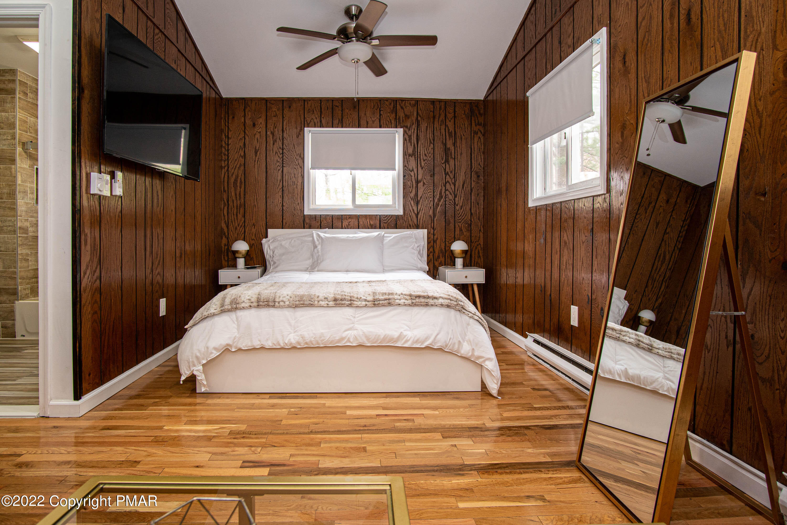 125 Edinburgh Road Bushkill, PA 18324 - Photo 23 of 64 a large bedroom with a bed wooden floor and flat screen tv