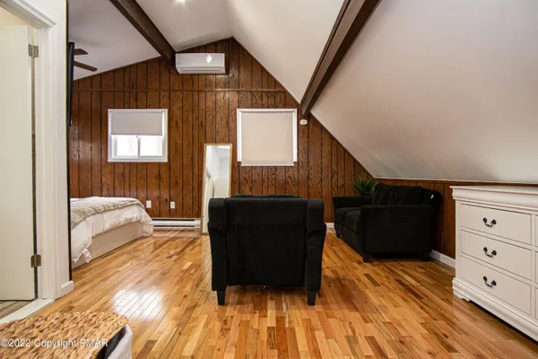 a bedroom with furniture and a flat screen tv