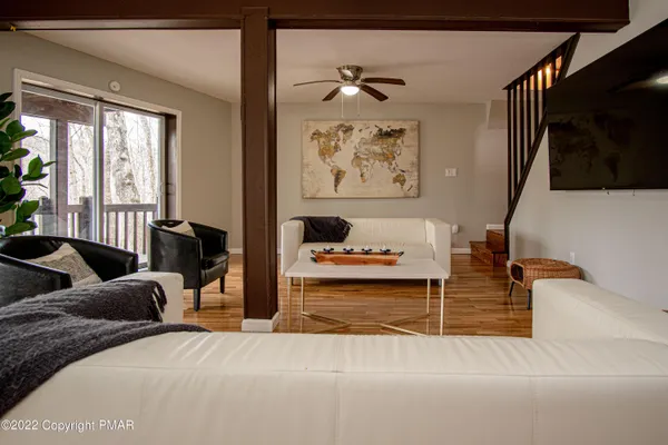 a view of backyard with large window and wooden floor