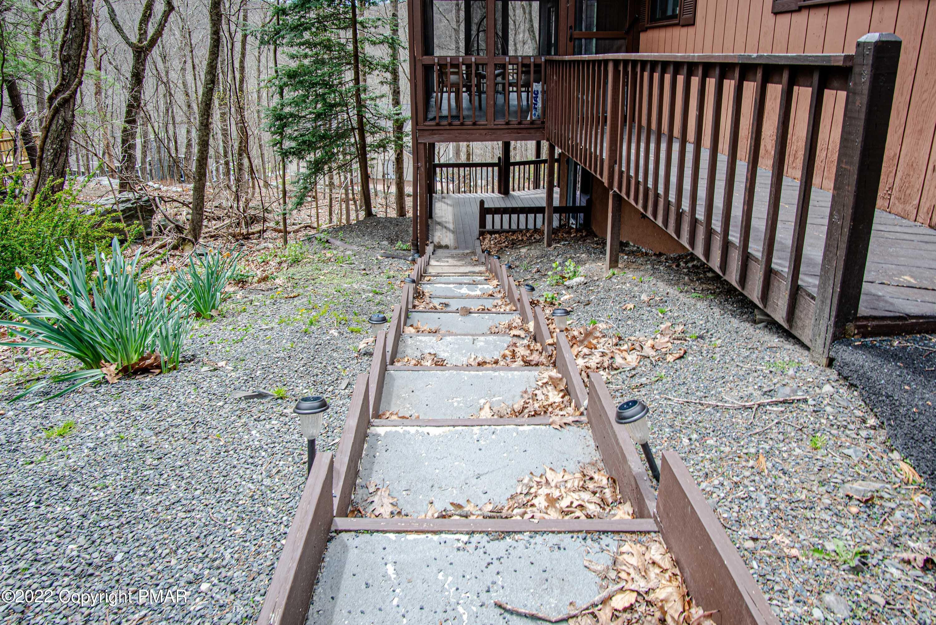 125 Edinburgh Road Bushkill, PA 18324 - Photo 40 of 64 a view of a porch with a bench