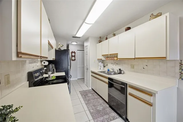 a kitchen with stainless steel appliances a sink stove and refrigerator