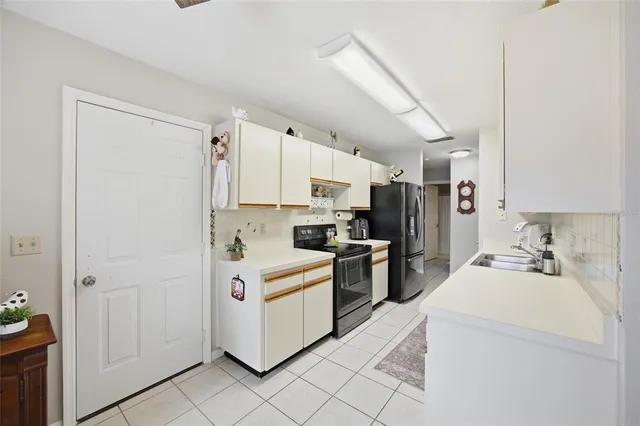 a kitchen with a sink a stove and refrigerator