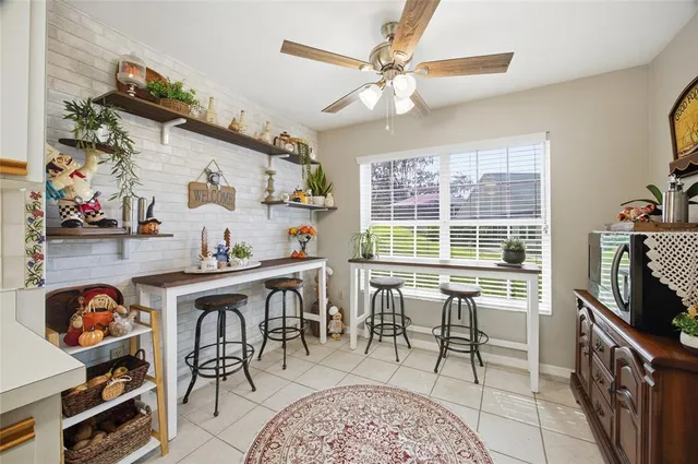 a view of a dining room with furniture a rug and wooden floor