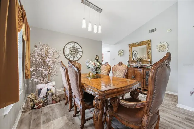 a view of a dining room with furniture and a chandelier