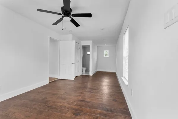 a view of an empty room with wooden floor