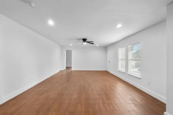 wooden floor in an empty room with a window
