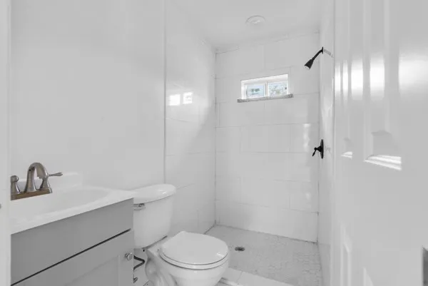 a bathroom with a toilet sink and shower