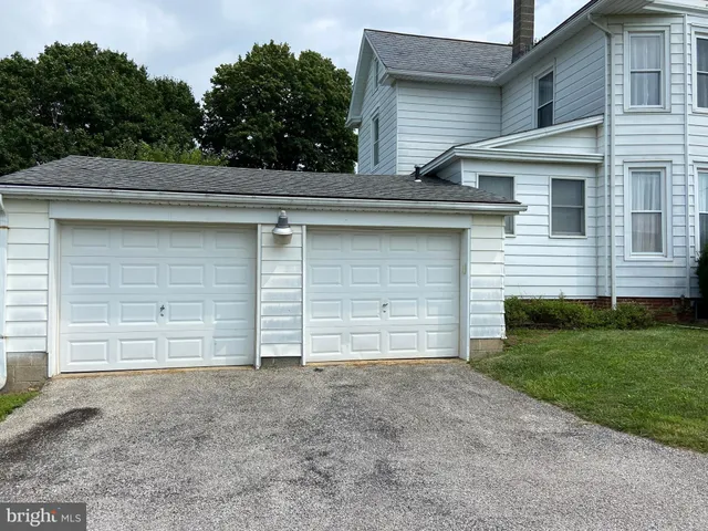 a view of house with backyard space and wooden fence