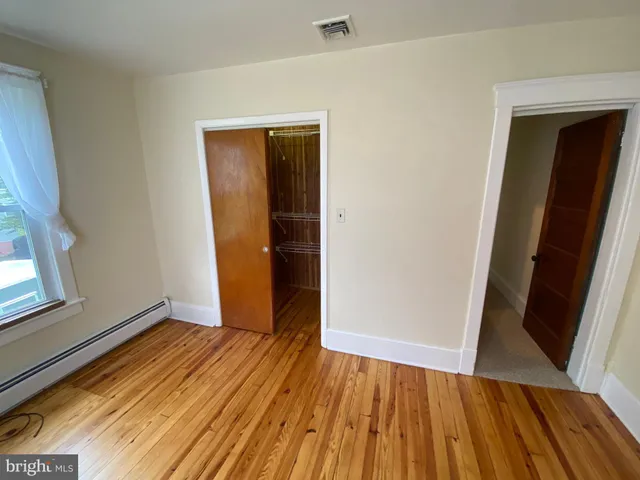 a view of a room with wooden floor and gate