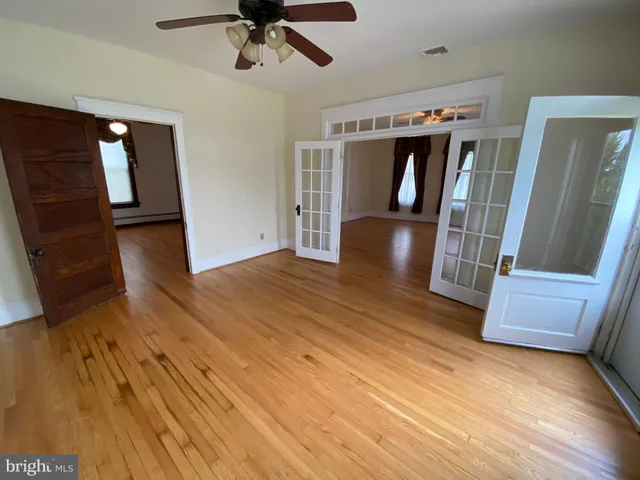 a view of an empty room and wooden floor