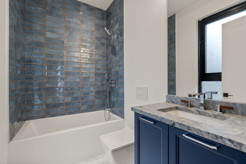 45 Stearns Road, Unit PH Brookline, MA 02446 - Photo 16 of 19 a bathroom with a granite countertop bathtub sink vanity and mirror
