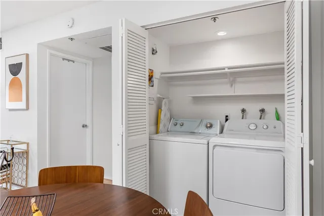 a view of kitchen with stainless steel appliances cabinets and wooden floor